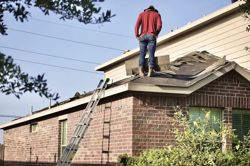 Professional roofer working on a residential roof in Nolte